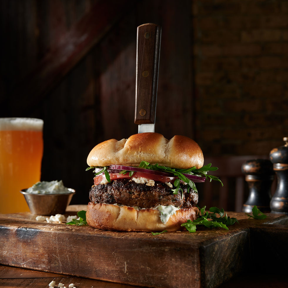 a lamb burger with a lager beer being served at a restaurant